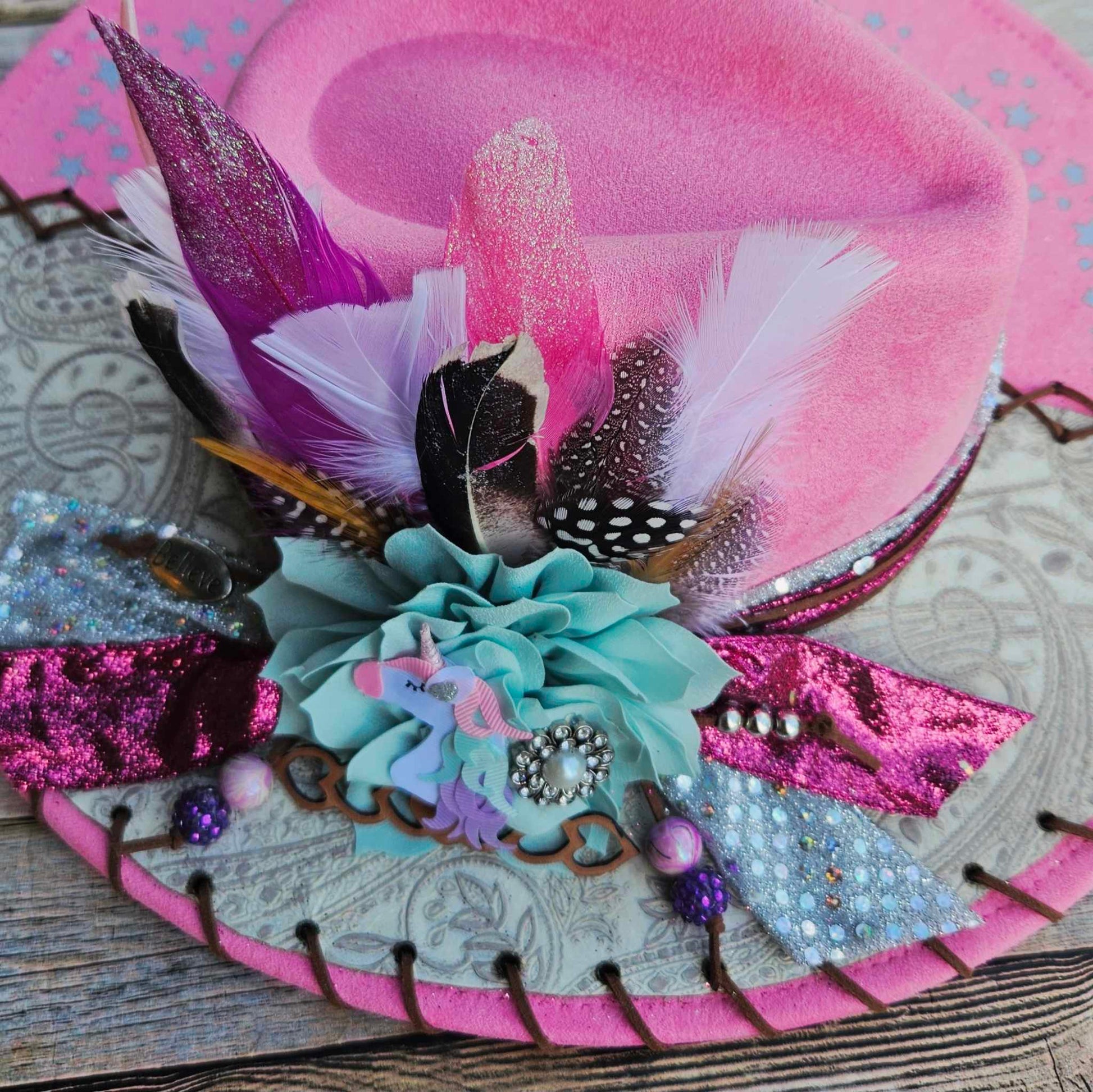 pink felt wide brim hat, unicorn painted hat, wide brim feathered hat, leather laced hat, hand crafted wide brim hat. adjustable pink hat