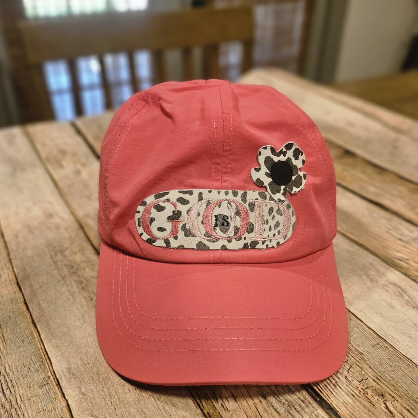 coral crisscross cap with black and white leopard leather "God is Good" patch