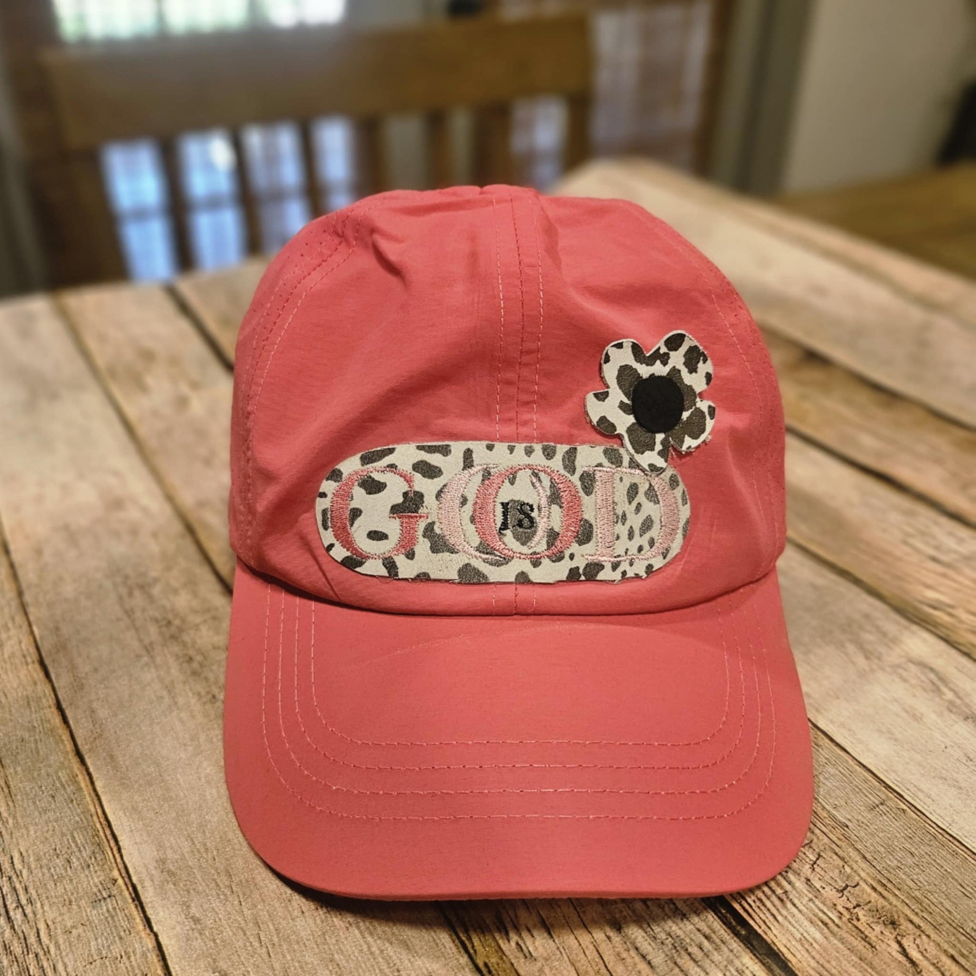 coral crisscross cap with black and white leopard leather "God is Good" patch