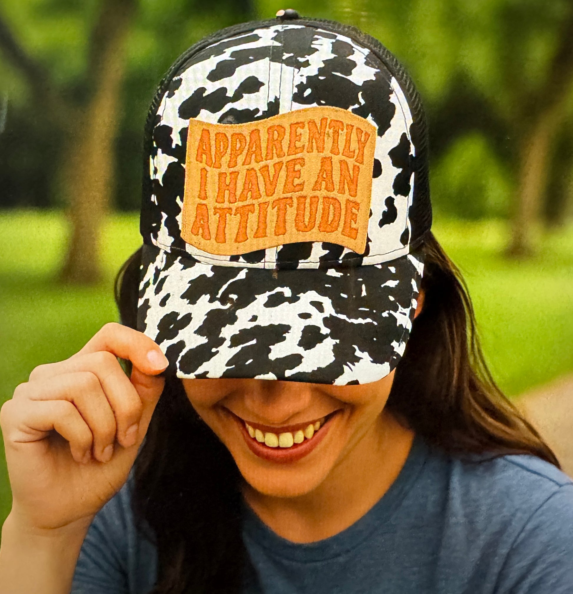 black and white cow print crisscross cap, crisscross ponytail cap, apparently, I have an attitude leather embroidered patch cap, coral embroidered leather patch cap