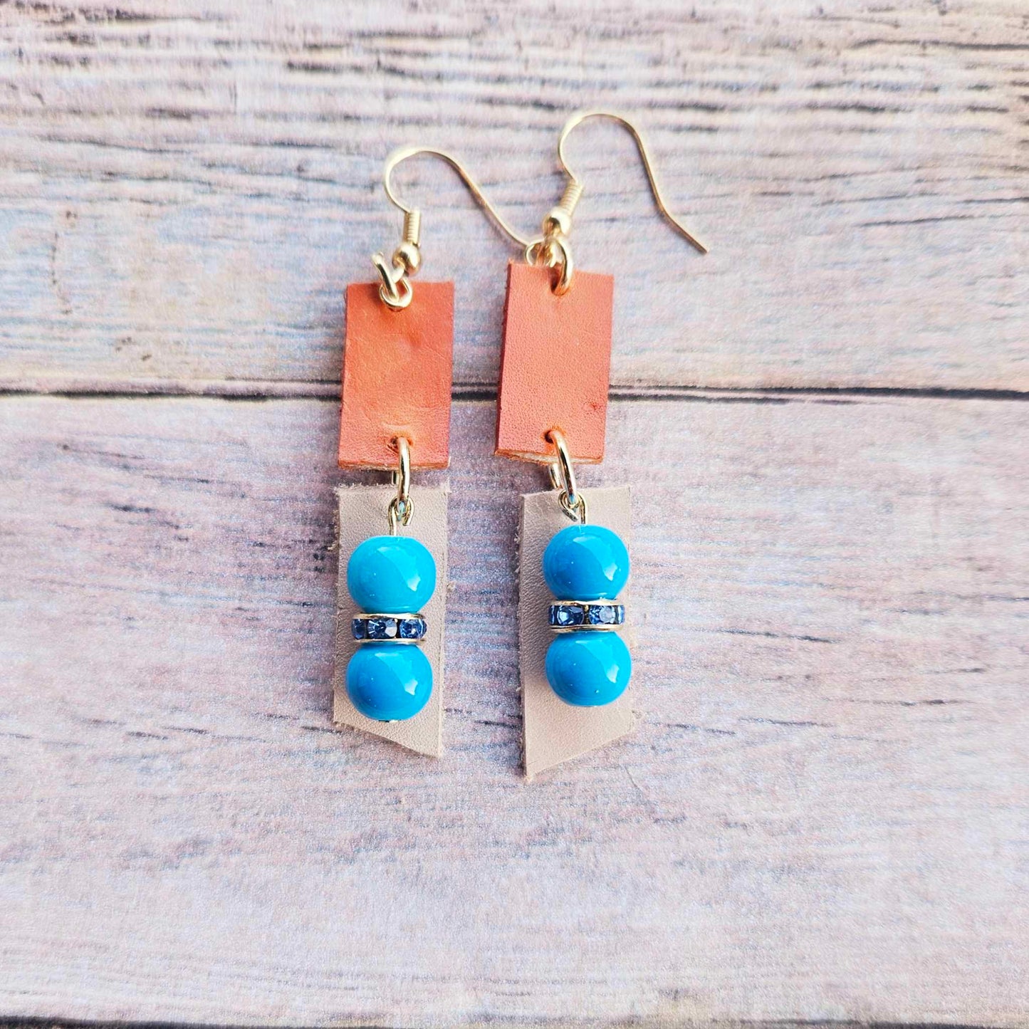 veg tan leather, orange leather, blue rhinestone spacers, turquoise beads, gold earrings, handmade jewelry