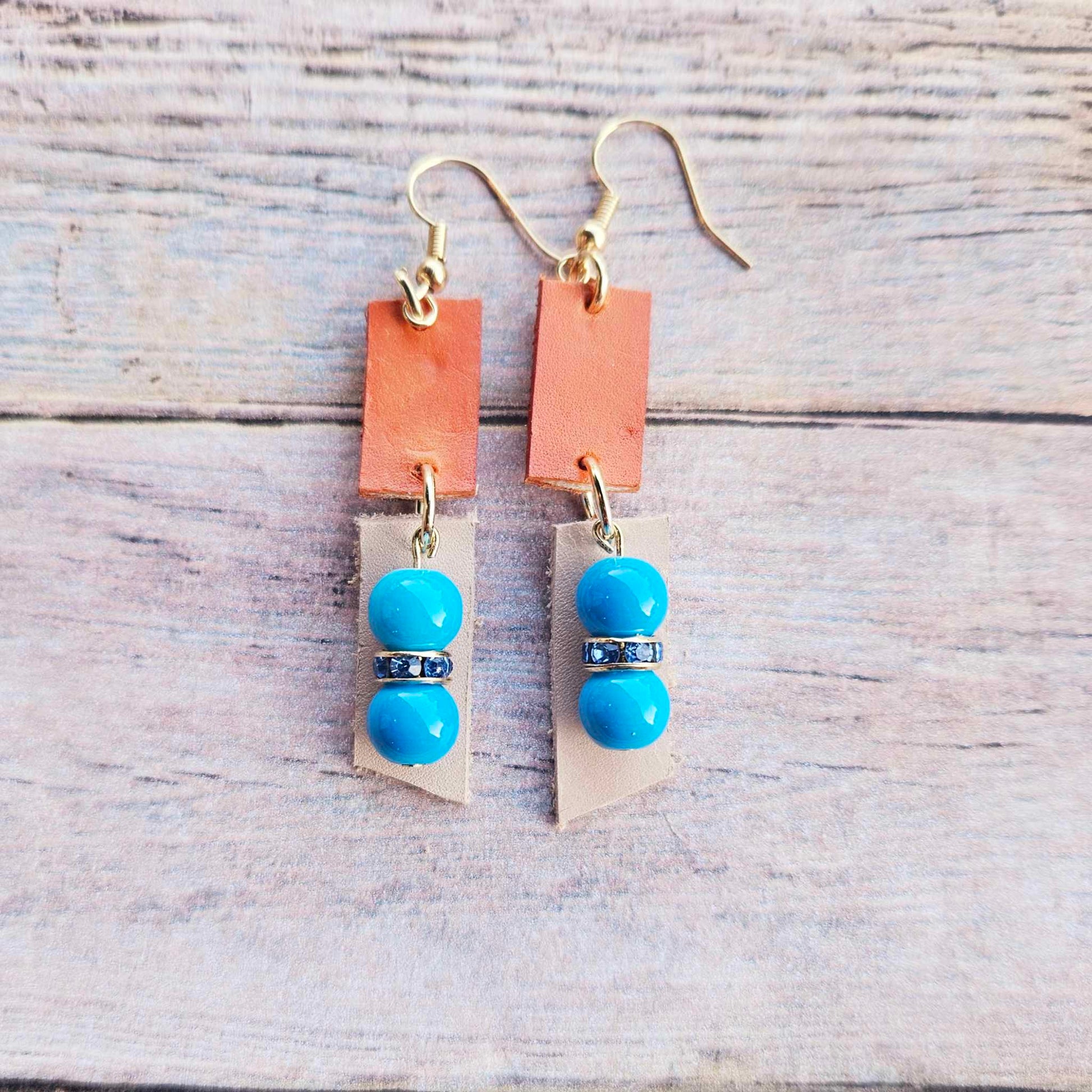 veg tan leather, orange leather, blue rhinestone spacers, turquoise beads, gold earrings, handmade jewelry