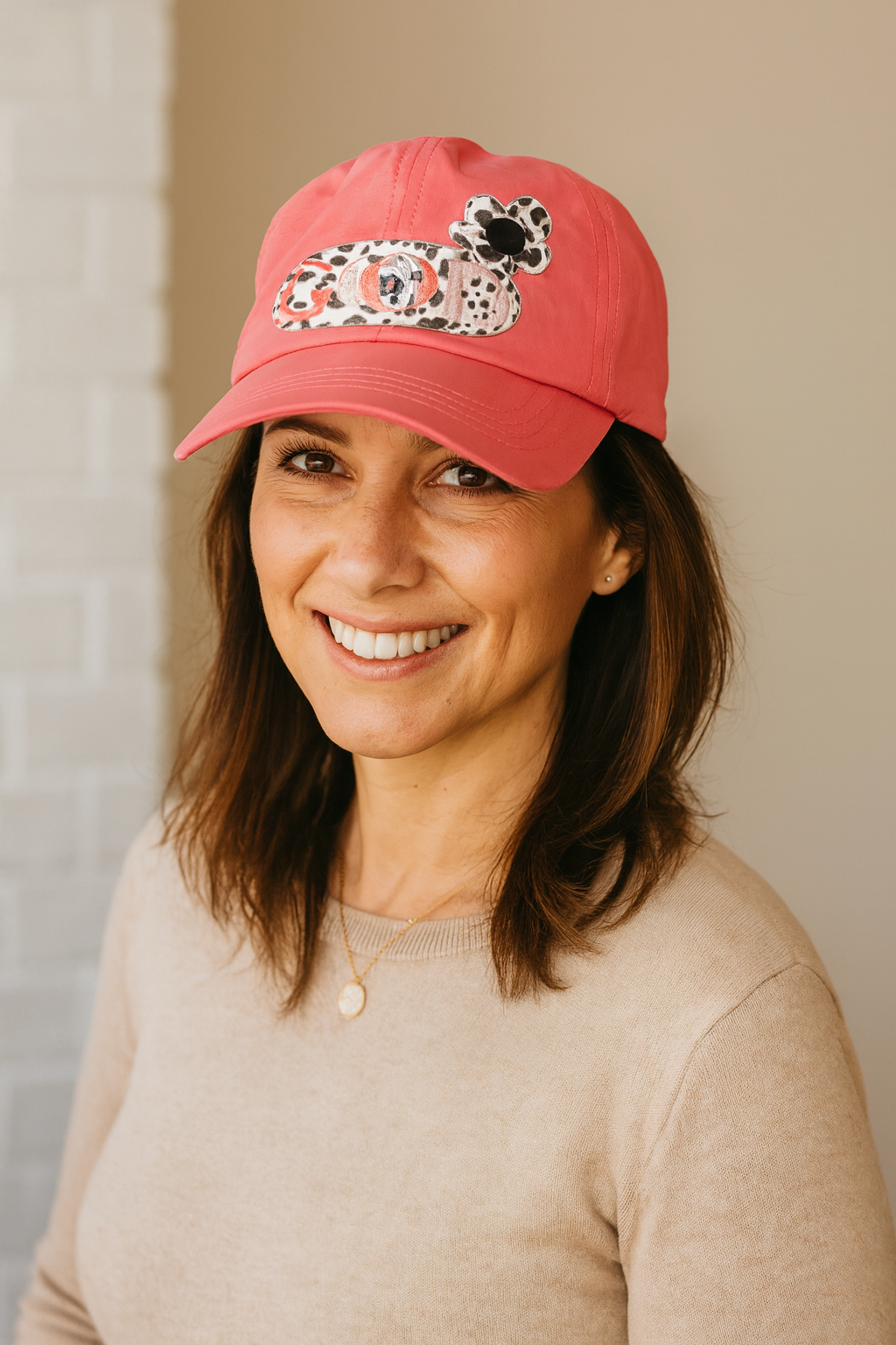 coral crisscross cap with black and white leopard leather "God is Good" patch