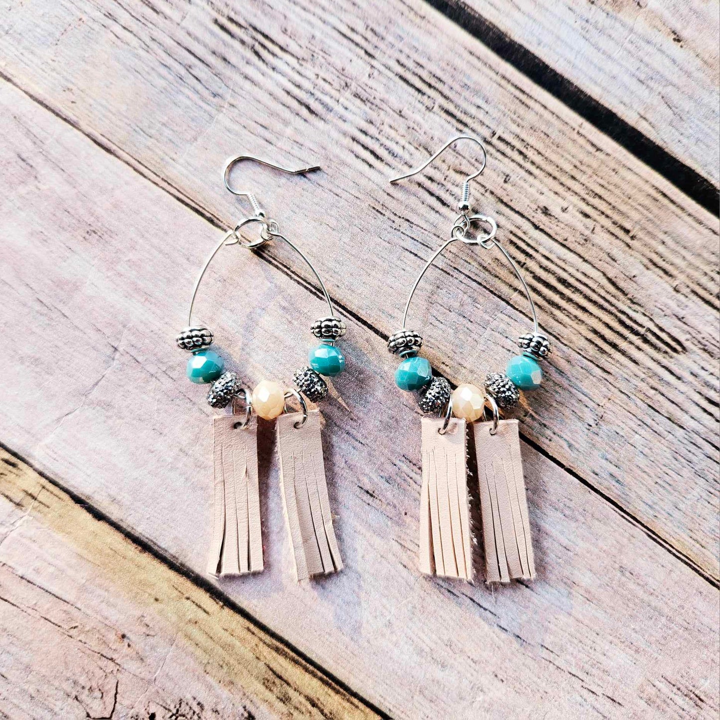 silver hoop earrings, veg tan leather tassels, turquoise and champagne crystal beads, handmade jewelry