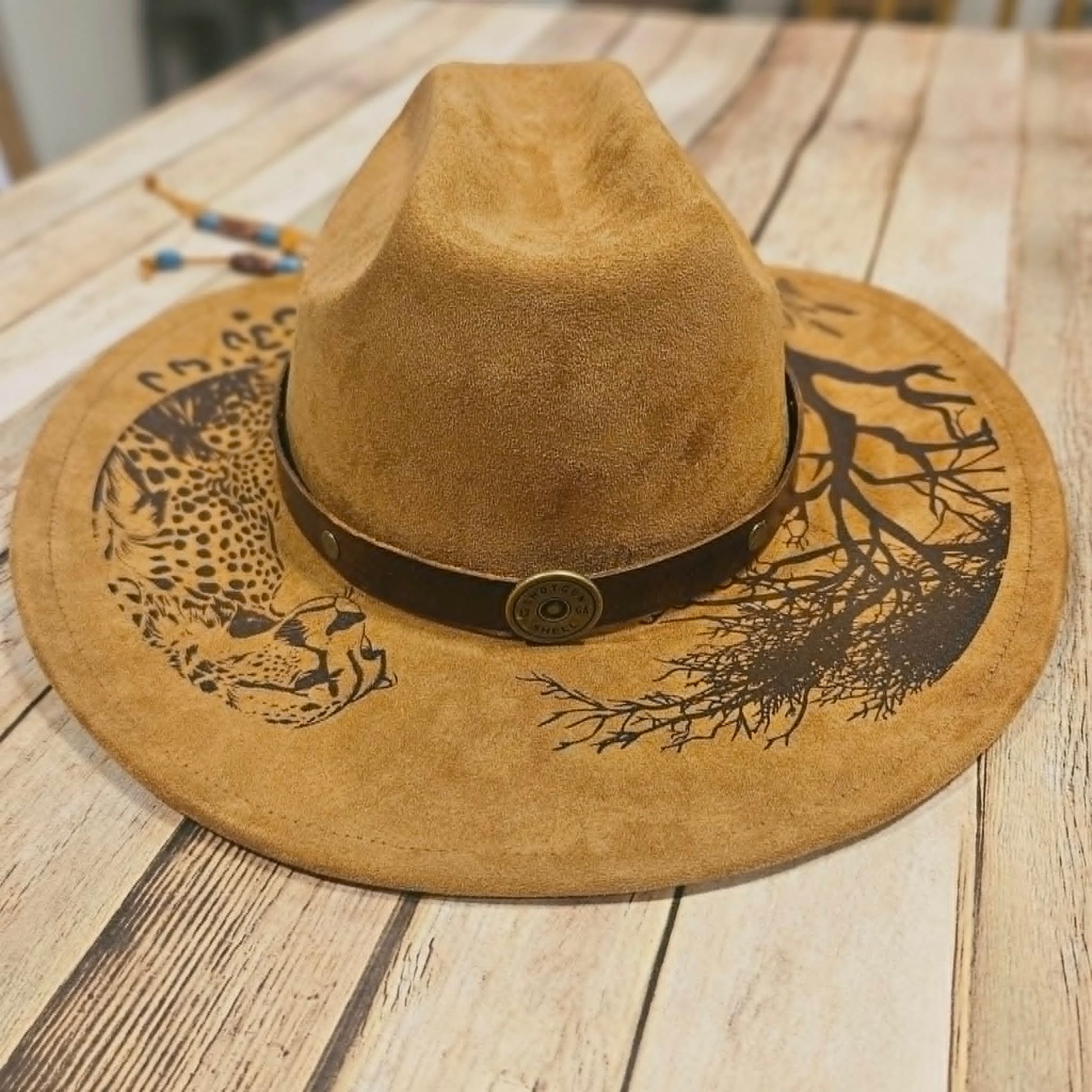 Brown suede hat with decorative band, cougar burned large brim hat, willow tree burned hat, laser decorated large brim hat, camel colored leopard burned hat