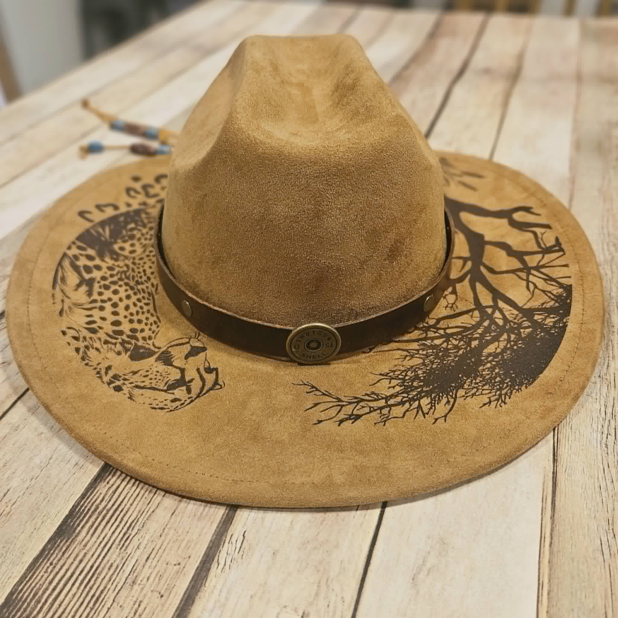 Brown suede hat with decorative band, cougar burned large brim hat, willow tree burned hat, laser decorated large brim hat, camel colored leopard burned hat