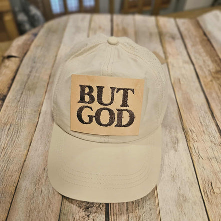 off white crisscross ponytail cap with "but God"  embroidered leather patch