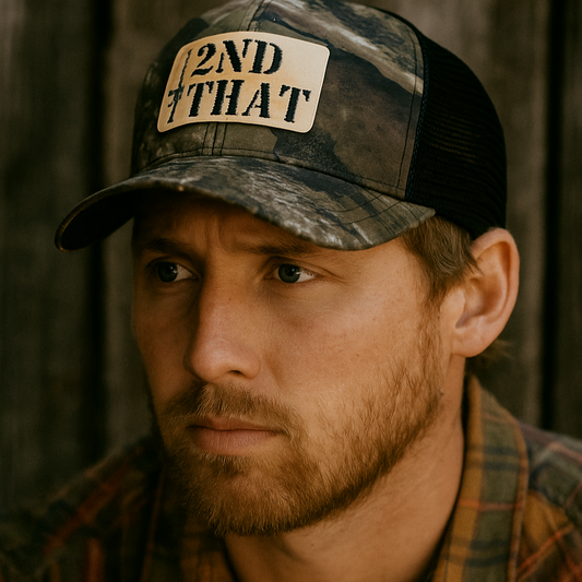 Man wearing a camouflage cap with '2nd Man That' patch 