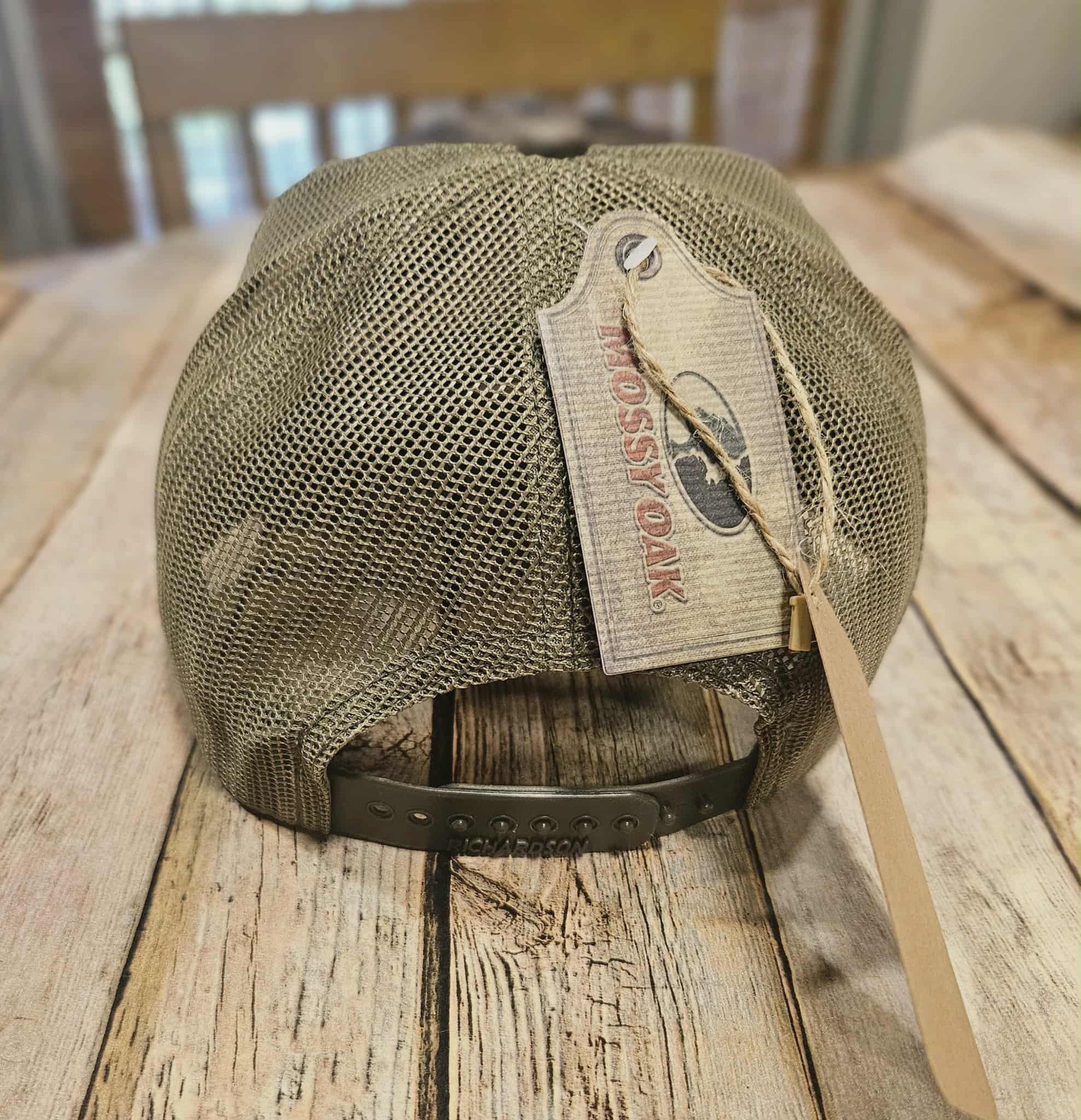 Mesh cap with a tag on a wooden surface
